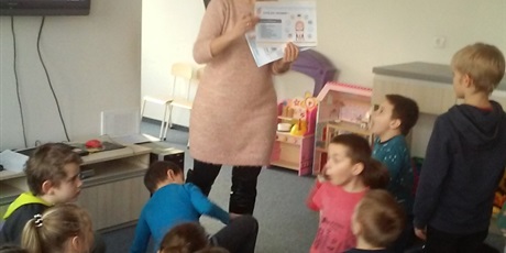 Powiększ grafikę: nauczyciel prezentuje dzieciom plansze tematyczne