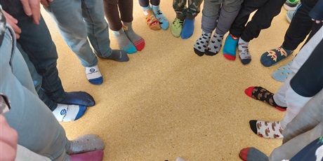 Powiększ grafikę: Dziecięce stopy w kolorowych skarpetkach.